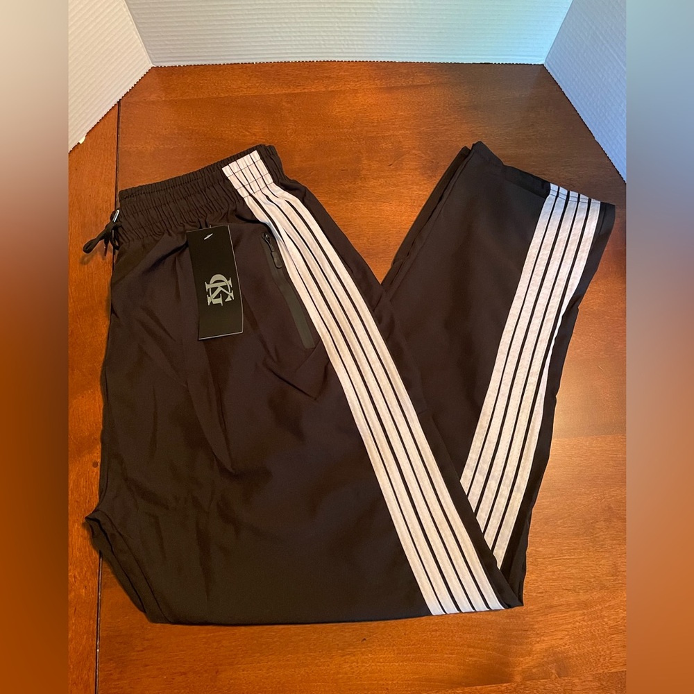 Men’s warmup pants. Black with white stripes. NWT